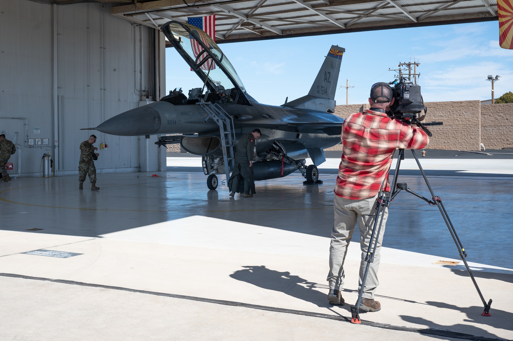 Fox News videographer, Bryan Allman, films correspondent, Matt Finn, as he prepares for flight in an F-16 to highlight air defense security efforts that will be in place over State Farm Stadium in Glendale, Arizona, during Super Bowl LVII on Feb. 12. (U.S. Air Force photo by Maj. Angela Walz)