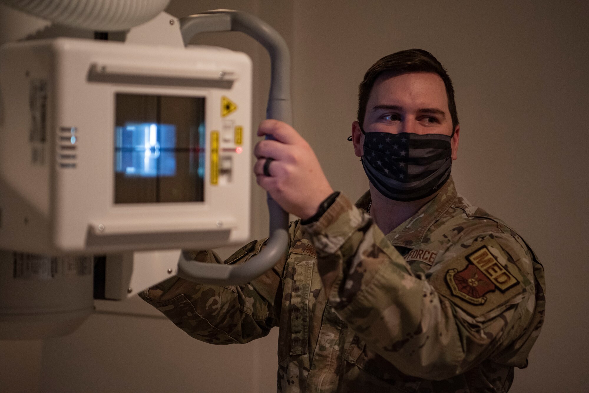 U.S. Air Force Staff Sgt. Anthony Hiser, 7th Health Care Operations Squadron diagnostic imaging technologist, adjusts an X-ray machine at Dyess Air Force Base, Texas, Feb. 8, 2023. The Dyess Radiology Clinic ensures military personnel and their families receive quality health care by taking X-ray images that are digitally transmitted through the picture archiving and communication system to be read by a radiologist at Travis AFB, California. (U.S. Air Force photo by Airman 1st Class Ryan Hayman)