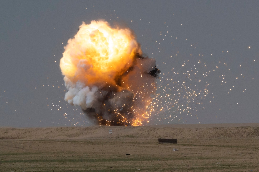 An explosive detonates in a field.