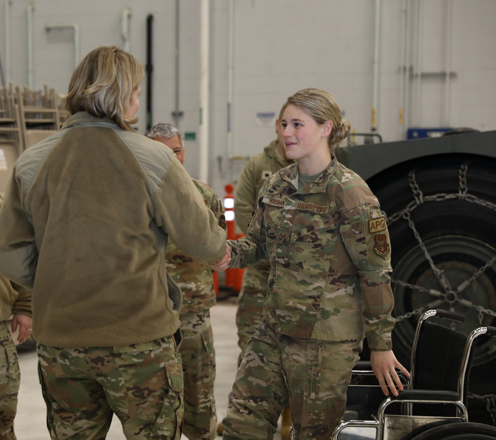 Maj. Gen. C. McCauley von Hoffman, Director of Logistics, Civil Engineering, Force Protection and Nuclear Integration, Headquarters Air Force Materiel Command, coins Staff Sgt. Molly Hageman, 445th Aircraft Maintenance Squadron aircraft maintenance craftsman, for being an outstanding performer Jan. 8, 2023. Five Airmen were coined by the general for being their group’s outstanding performer; three from the 445th Maintenance Group and two from the 445th Mission Support Group. While at the wing, the general received an overview briefing from both the 445th MSG and MXG, she met with 21X officers during a senior leader perspective discussion, had lunch with both 445th MXG and MSG leadership and toured various maintenance facilities.