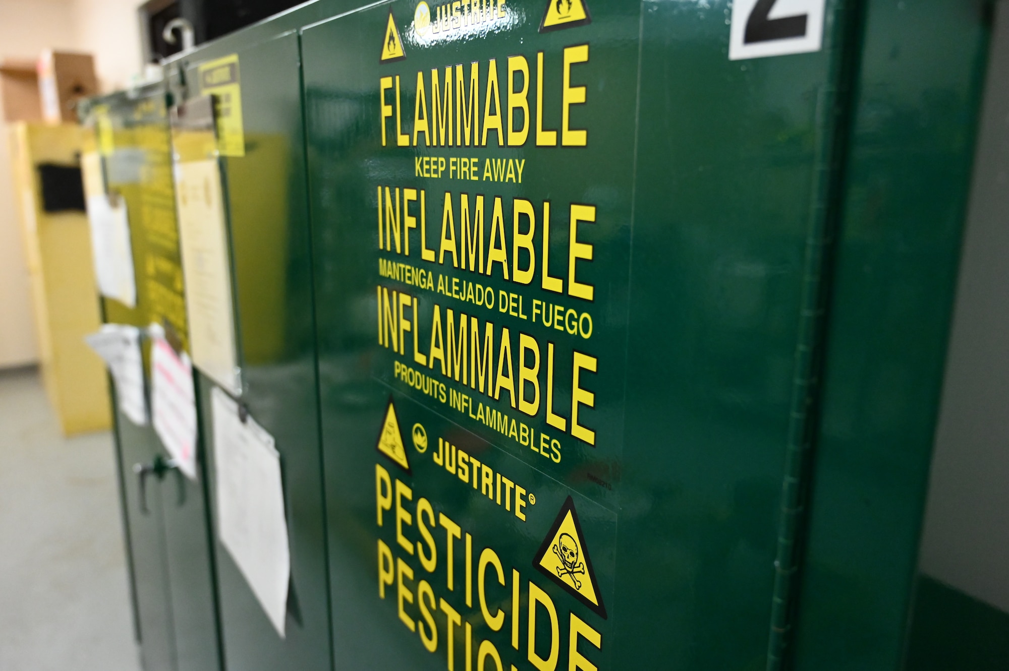 Insecticides are properly stored with caution signs in the pest management shop at Joint Base Lewis-McChord, Washington, Feb. 6, 2023. The chemicals stored here are used to spray the interior of an aircraft to prevent the transfer of mosquitos carrying the Zika virus to other countries.  (U.S. Air Force photo by Senior Airman Callie Norton)