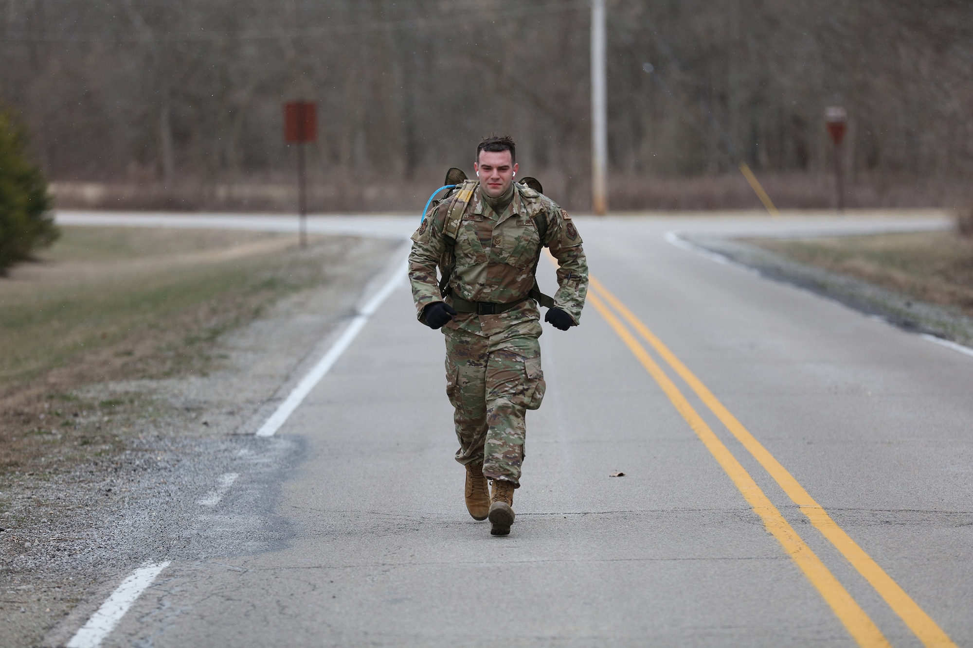 Tech. Sgt. Gabriel Clark, 87th Aerial Port Squadron ramp operations representative, pushes through a 12k ruck-march during the German Armed Forces Military Proficiency Badge qualification at Wright-Patterson Air Force Base, Ohio, Feb. 3, 2023.