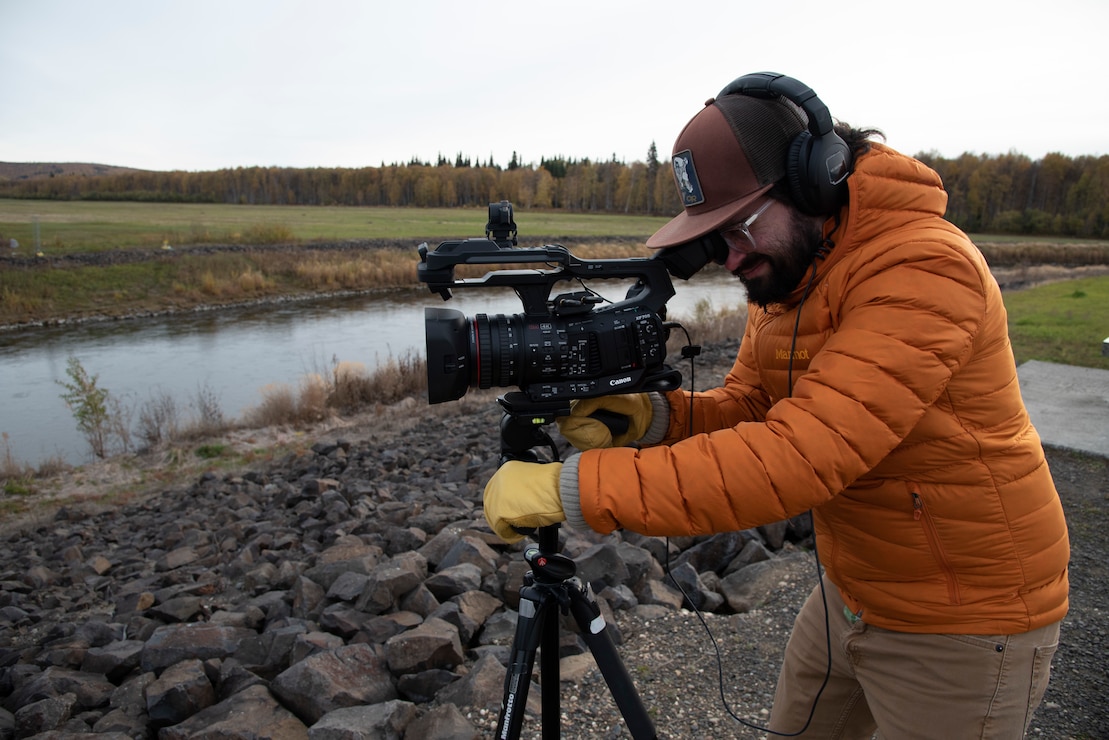 John Budnik, public affairs specialist, films a public service announcement for the Chena River Lakes Flood Control Project in North Pole, Alaska. The video explains the role of the Moose Creek Dam in protecting the Fairbanks community from seasonal flooding.