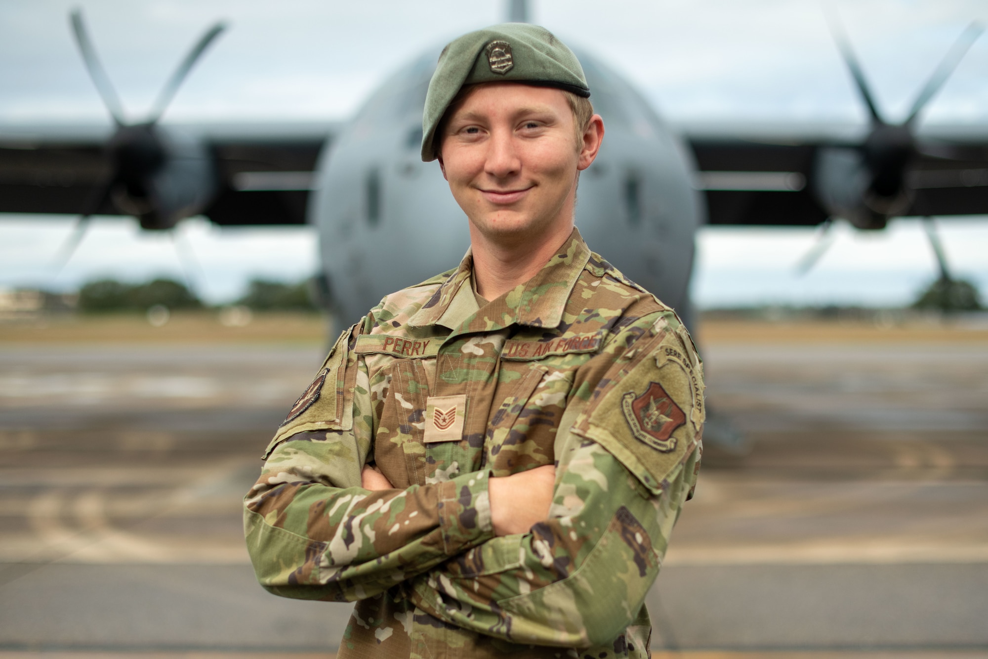 Tech Sgt Perry stands directly in front of a C-130J