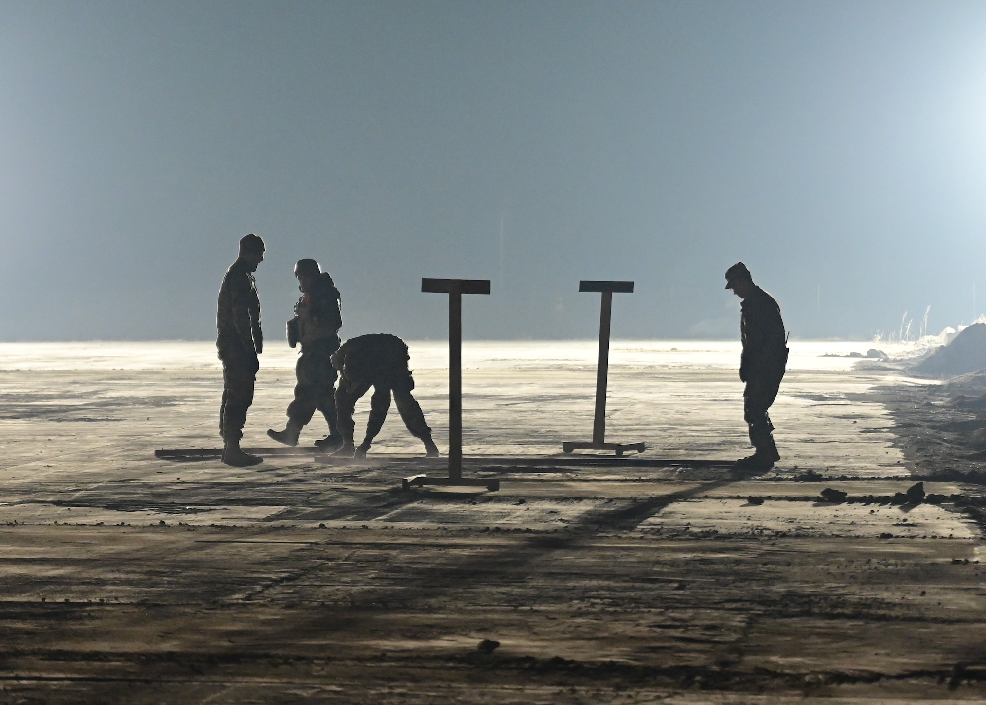 U.S. Air Force service members from the 8th Civil Engineer Squadron (CES) mark and inspect simulated damage during rapid airfield damage repair (RADR) training at Kunsan Air Base, Republic of Korea, Feb. 7, 2023. The 8th CES RADR teams assessed simulated airfield craters, made repairs and proved their ability to ensure flightline operability. (U.S. Air Force photo by Staff Sgt. Isaiah J. Soliz)