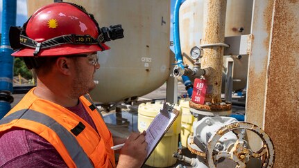 An environmental technician conducts hourly pressure gauge checks on the water tanks outside the Red Hill Bulk Fuel Storage Facility in Halawa, Hawaii, Feb. 8, 2023. The pressure gauge accurately measures the pressure in which the water flows in and out of the water tanks. Water from the aquifer is first pumped into the water tanks, which is then cycled into the analyzer shed–where the water is constantly analyzed for possible contaminants–and is then recycled back into the aquifer. (U.S. Army photo by Spc. Matthew Mackintosh)