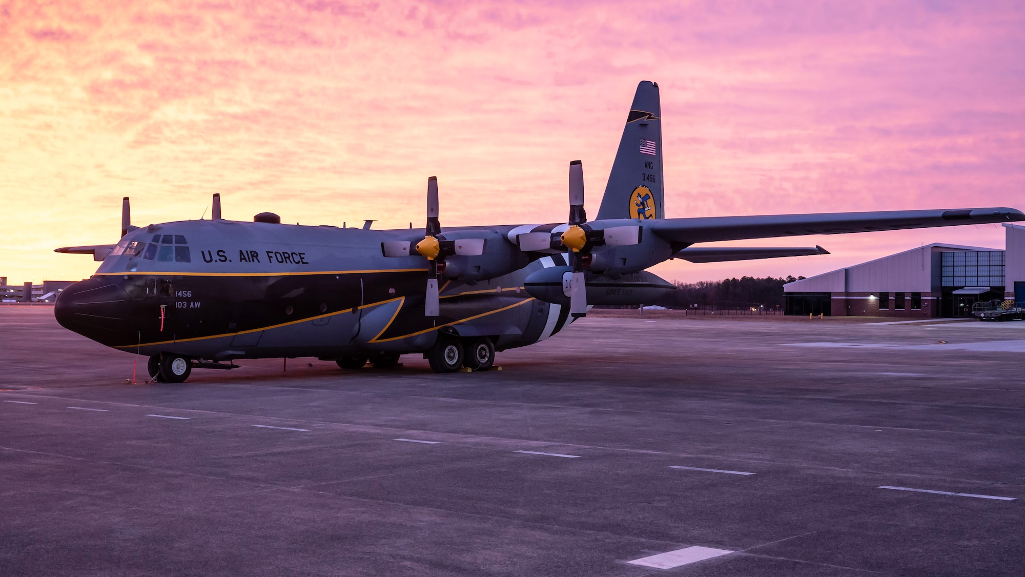 A C-130H aircraft, painted to commemorate the 100th anniversary of the 118th Airlift Squadron, Flying Yankees, sits on the flight line at sunrise, January 18, 2023 at Bradley Air National Guard Base, Conn. Members of the 103rd Maintenance Group, Connecticut Air National Guard painted the aircraft. (U.S. Air National Guard photo by Master Sgt. Tamara R. Dabney)