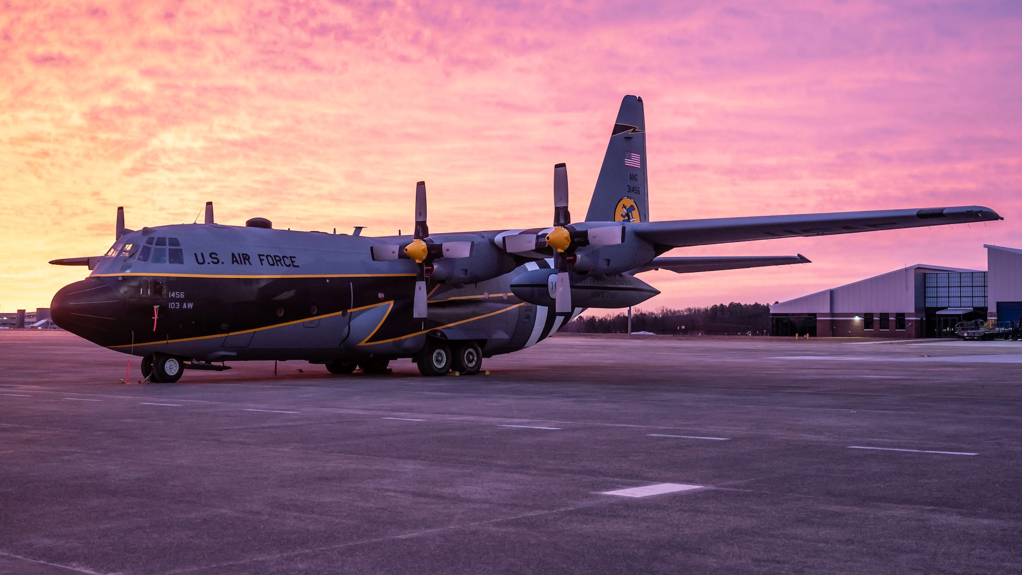 A C-130H aircraft, painted to commemorate the 100th anniversary of the 118th Airlift Squadron, Flying Yankees, sits on the flight line at sunrise, January 18, 2023 at Bradley Air National Guard Base, Conn. Members of the 103rd Maintenance Group, Connecticut Air National Guard painted the aircraft. (U.S. Air National Guard photo by Master Sgt. Tamara R. Dabney)