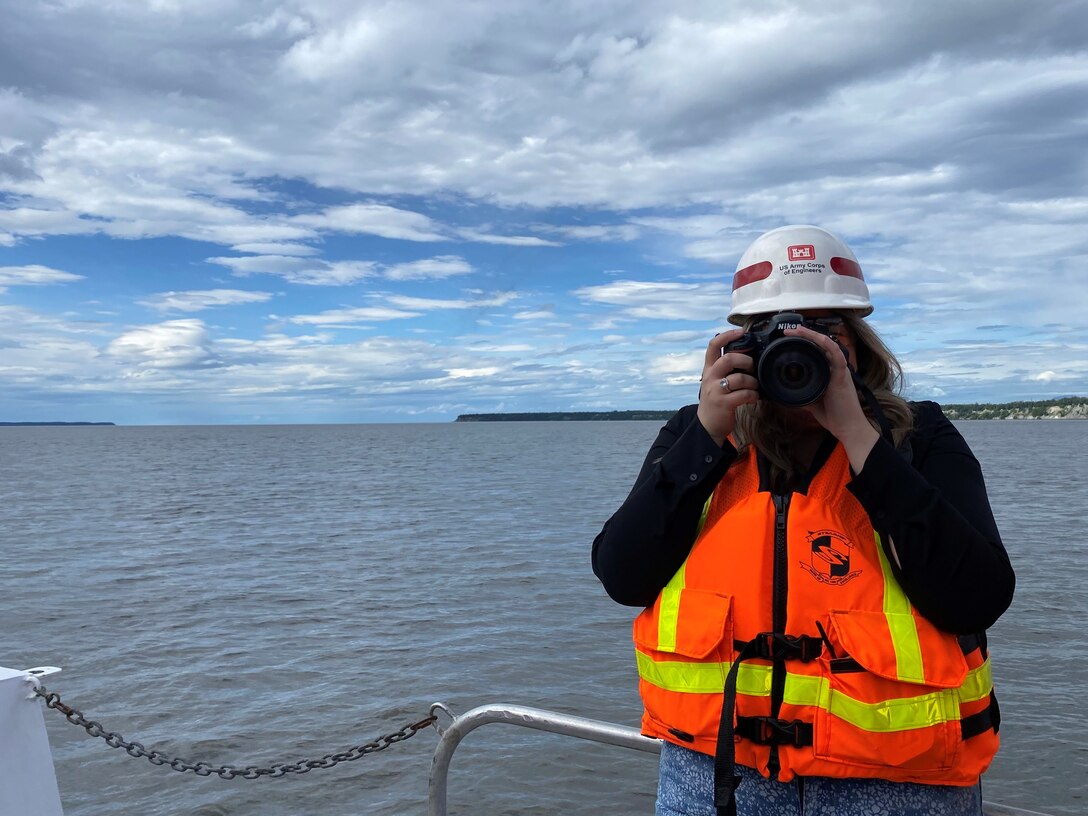 Rachel Napolitan, public affairs specialist, takes a photo while touring the dredge contracted by the U.S. Army Corps of Engineers - Alaska District in the Port of Alaska. The Operations Branch performs annual maintenance dredging to remove underwater sediment and shoaled materials built up at the port to ensure vital navigation channels remain open and the port is accessible to shipping traffic at all times.