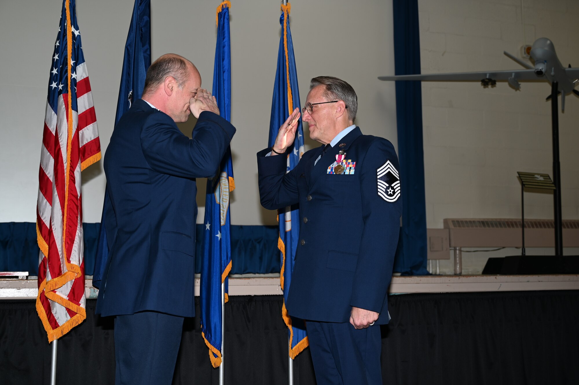 Two men in Air Force Dress Blues render a salute.