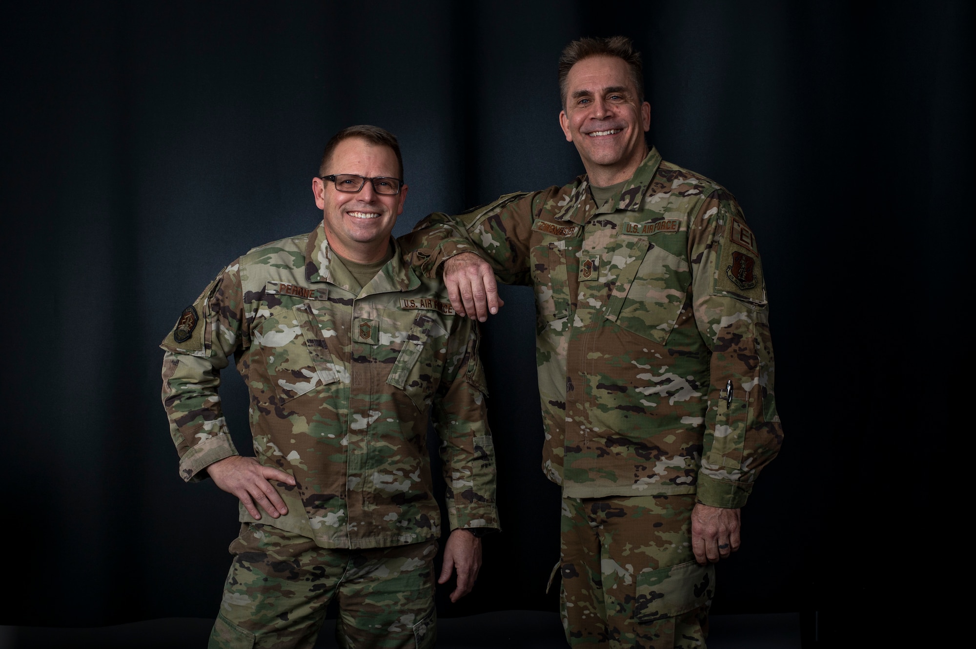 Senior Master Sgt. Lance Perone, left, and Chief Master Sgt. Michael Zinsmeister, both with the 220th Engineering Installation Squadron, stand for a portrait Jan. 20, 2023, at Rickenbacker Air National Guard Base, Ohio. Perone and Zinsmeister are still serving together after being in the same basic training flight over 33 years ago.