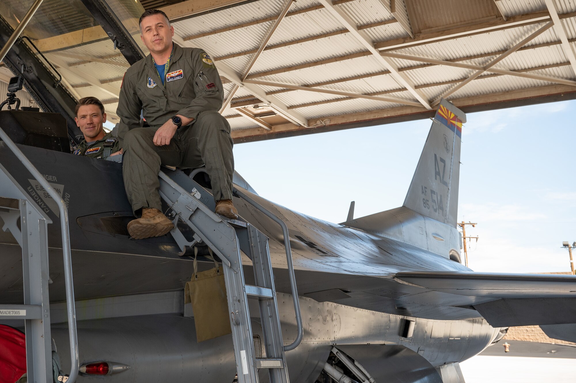 Fox News correspondent, Matt Finn, and Lt. Col. Jeramy Barnett, a 162nd Wing F-16 pilot, prepare for flight in an F-16 to highlight air defense security efforts that will be in place over State Farm Stadium in Glendale, Arizona, during Super Bowl LVII on Feb. 12. (U.S. Air Force photo by Maj. Angela Walz)