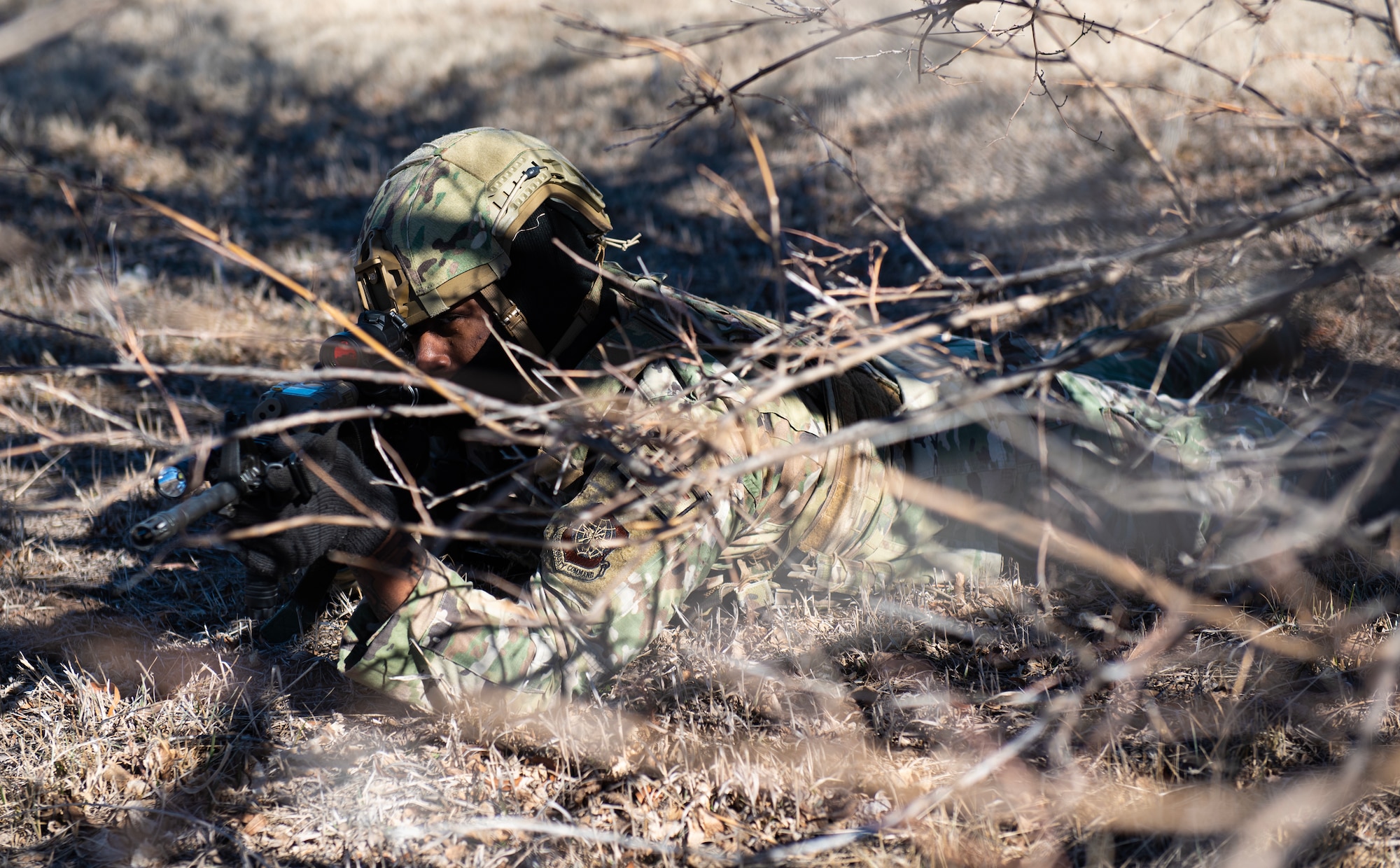Senior Airman Christopher Goodwyn, 22nd Security Forces Squadron patrolman, provides security for his team while clearing buildings during joint training at McConnell Air Force Base, Kansas, Feb. 3, 2023. Along with clearing buildings, the Airmen trained with U.S. Army Soldiers from the 3rd Assault Helicopter Battalion, 1st Aviation Regiment from Fort Riley, Kansas, to practice tactical takeoffs and landings in a UH-60 Blackhawk. (U.S. Air Force photo by Staff Sgt. Tryphena Mayhugh)