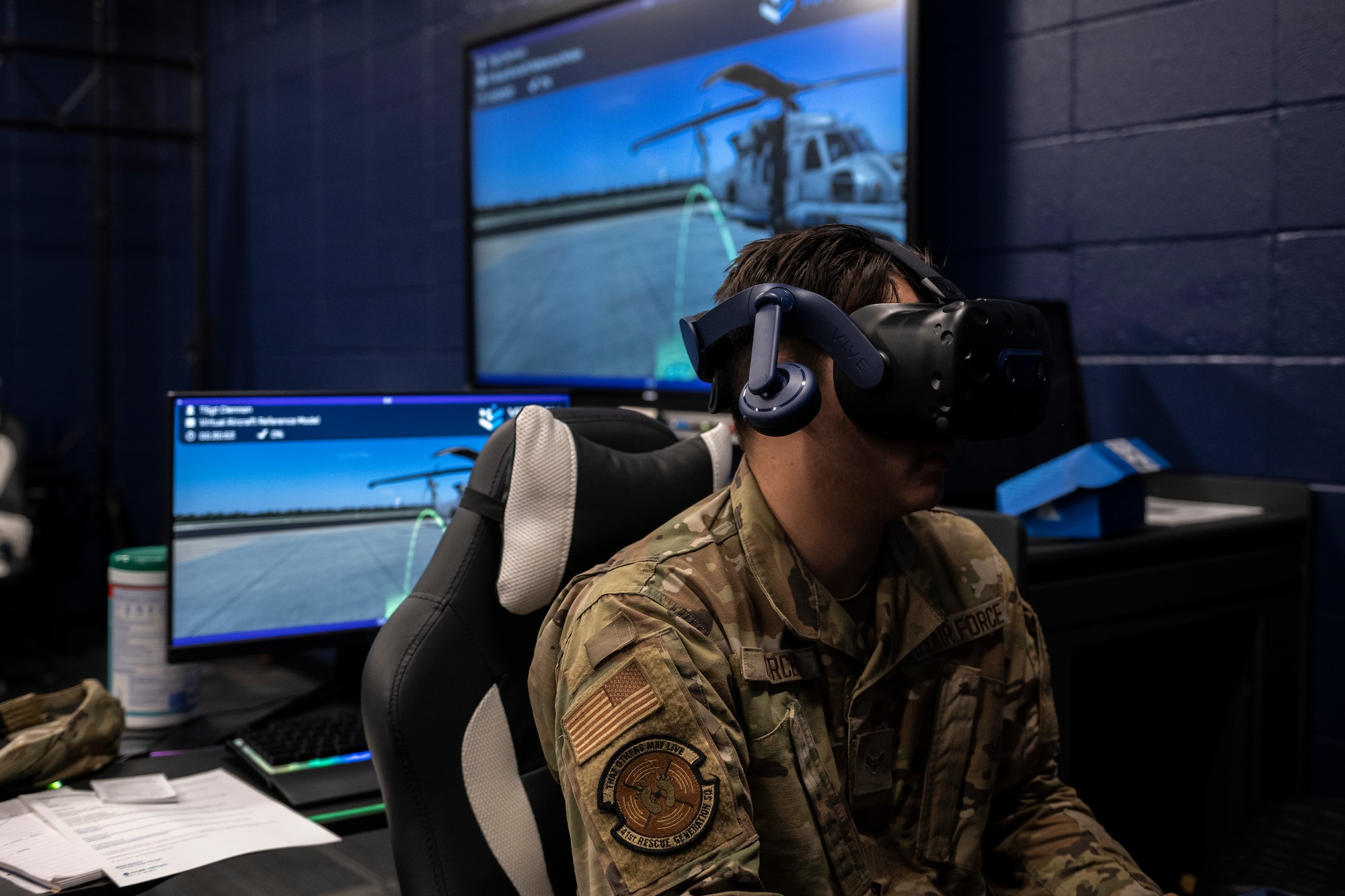 A photo on an Airman sitting in a chair with a VR headset on.