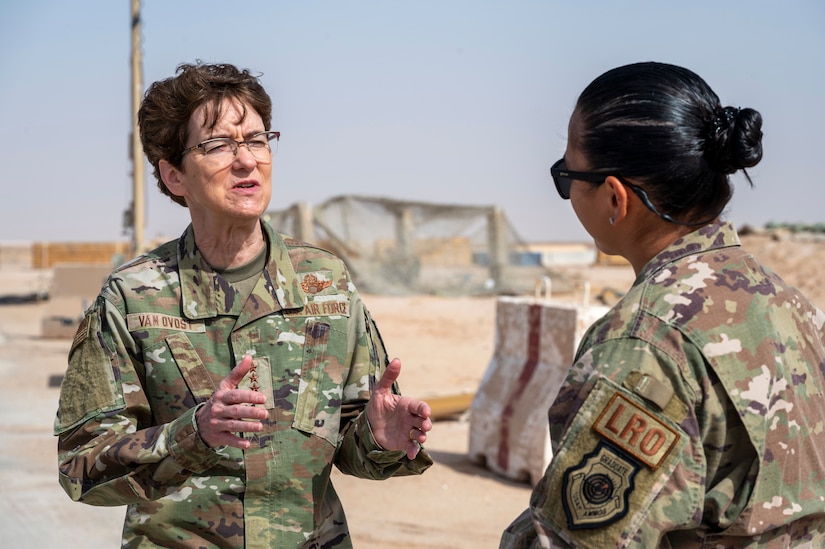 An air force general speaks with a major at a desert air base.