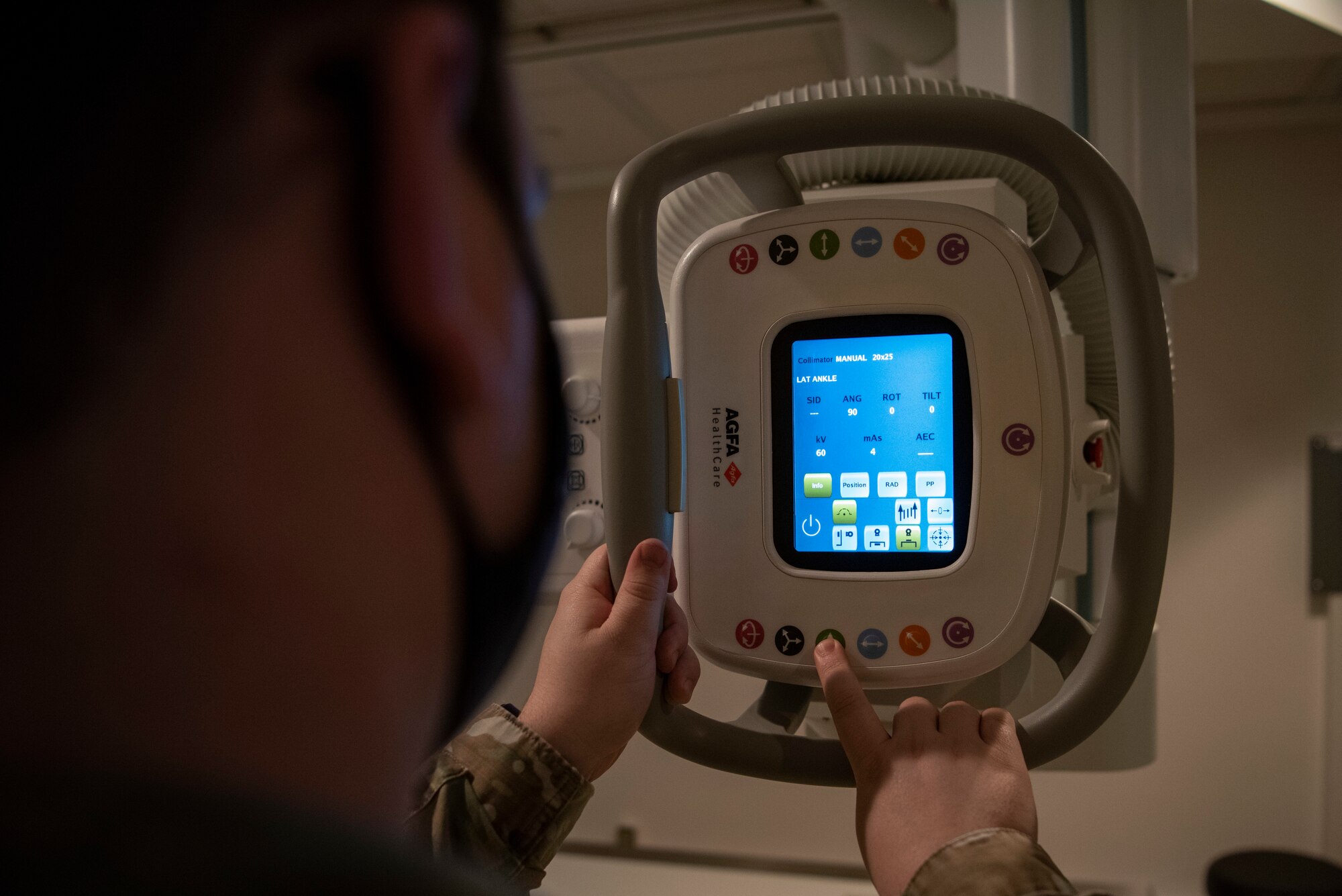 U.S. Air Force Staff Sgt. Anthony Hiser, 7th Health Care Operations Squadron diagnostic imaging technologist, adjusts the height setting on an X-ray machine at Dyess Air Force Base, Texas, Feb. 8, 2023.The Dyess Radiology Clinic ensures military personnel and their families receive quality health care by taking X-ray images that are digitally transmitted through the picture archiving and communication system to be read by a radiologist at Travis AFB, California. (U.S. Air Force photo by Airman 1st Class Ryan Hayman)
