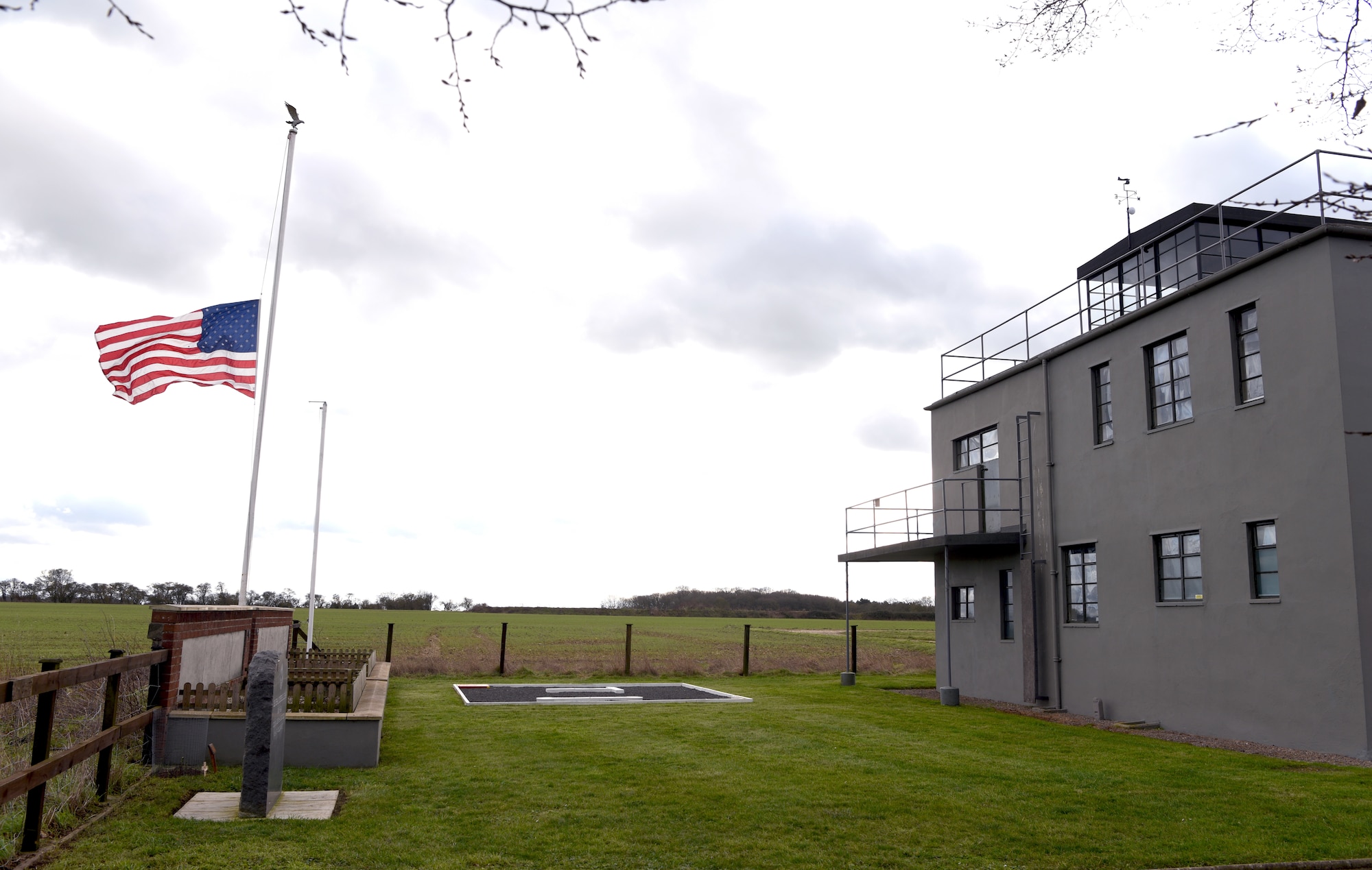 The Stars and Stripes flag flies at half staff at the 100th Bomb Group Memorial Museum, Thorpe Abbotts, England, Feb. 2, 2023, in honor of Staff Sgt. Al Arreola, World War II and 100th BG veteran, who passed away Feb. 1, 2023. Arreola was a 351st Bomb Squadron ball turret gunner based at Thorpe Abbotts during World War II and completed 35 missions during his time there. Airmen from today’s 351st Air Refueling Squadron performed a heritage patching ceremony at the former home of the 100th BG, and remembered the veteran and the legacy he and other World War II veterans have left behind. (U.S. Air Force photo by Karen Abeyasekere)