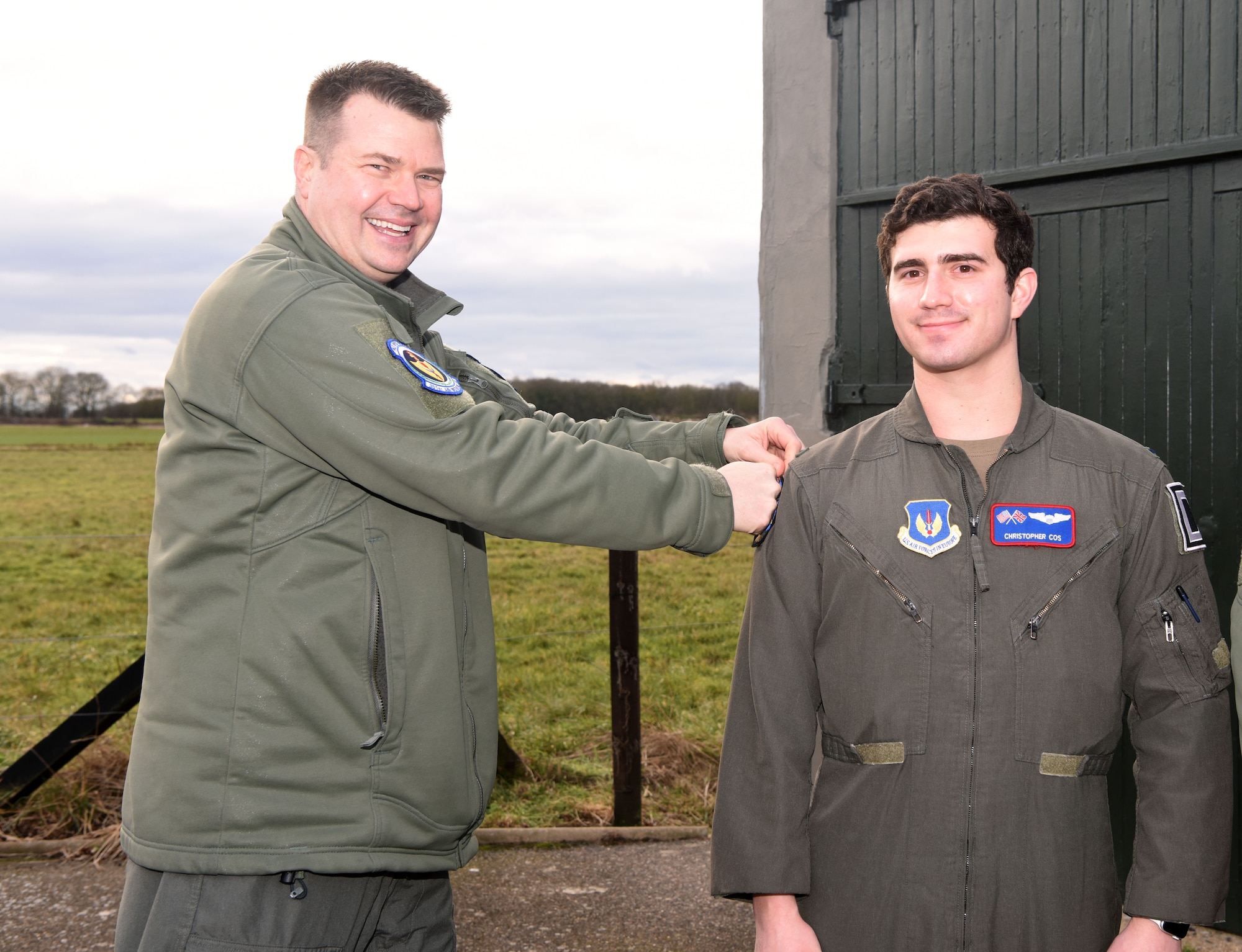 U.S. Air Force Lt. Col. Tyler Berge, left, 351st Air Refueling Squadron commander, presents the squadron heritage “Buzzard” patch to 1st Lt. Christopher Cos, 351st ARS co-pilot, at the 100th Bomb Group Memorial Museum, Thorpe Abbotts, England, Feb. 2, 2023. The heritage patch is presented to pilots and boom operators who have completed mission certification training. Thorpe Abbotts was home to the original 351st Bomb Squadron and 100th Bomb group during World War II. (U.S. Air Force photo by Karen Abeyasekere)