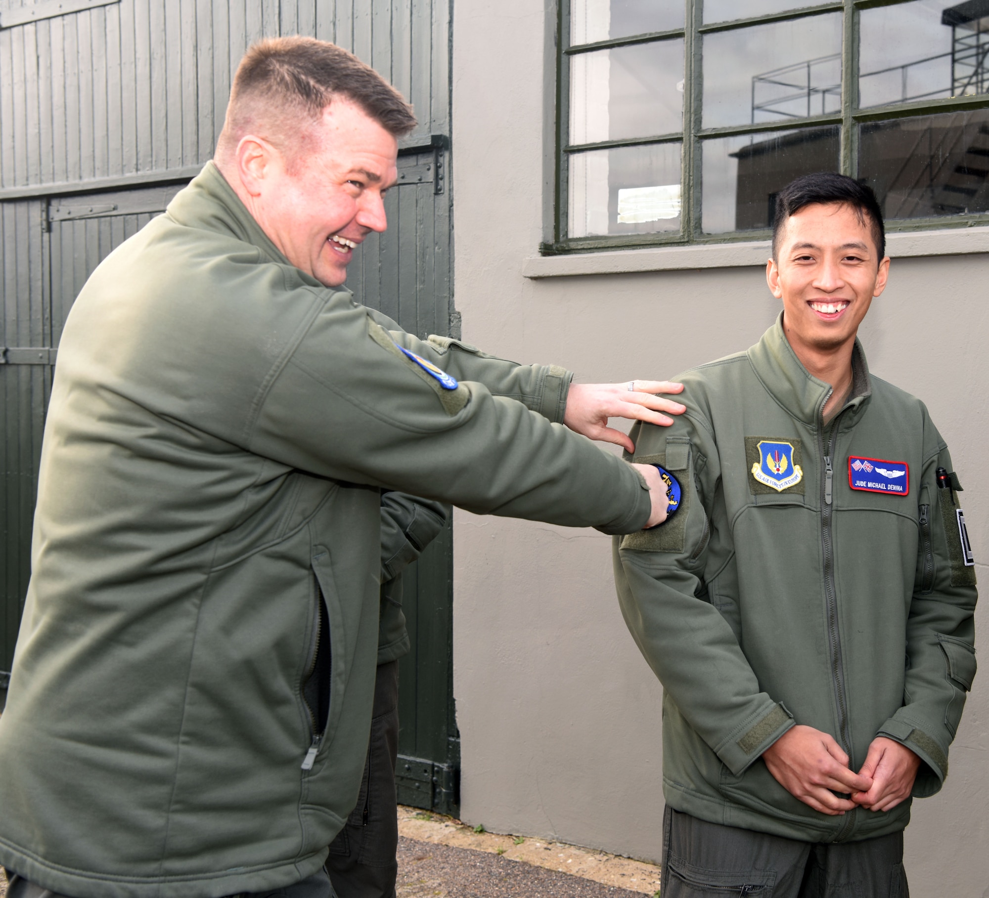 U.S. Air Force Lt. Col. Tyler Berge, left, 351st Air Refueling Squadron commander, presents the squadron heritage “Buzzard” patch to 1st Lt. Jude Michael Denina, 351st ARS co-pilot, at the 100th Bomb Group Memorial Museum, Thorpe Abbotts, England, Feb. 2, 2023. The heritage patch is presented to pilots and boom operators who have completed mission certification training. Thorpe Abbotts was home to the original 351st Bomb Squadron and 100th Bomb Group during World War II. (U.S. Air Force photo by Karen Abeyasekere)