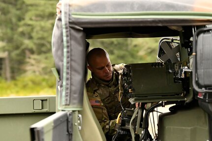 Washington National Guard Spc. Brady Dickinson with Charlie Company, 898th Brigade Engineer Battalion, 81st Stryker Brigade Combat Team, sets up long-range, mobile antenna systems on Joint Base Lewis-McChord, Wash., Feb. 4, 2023. The retransmitting teams and their equipment were sling-loaded to strategic battlefield locations by a CH-47 Chinook crewed by 1st Battalion, 168th General Support Aviation Regiment.