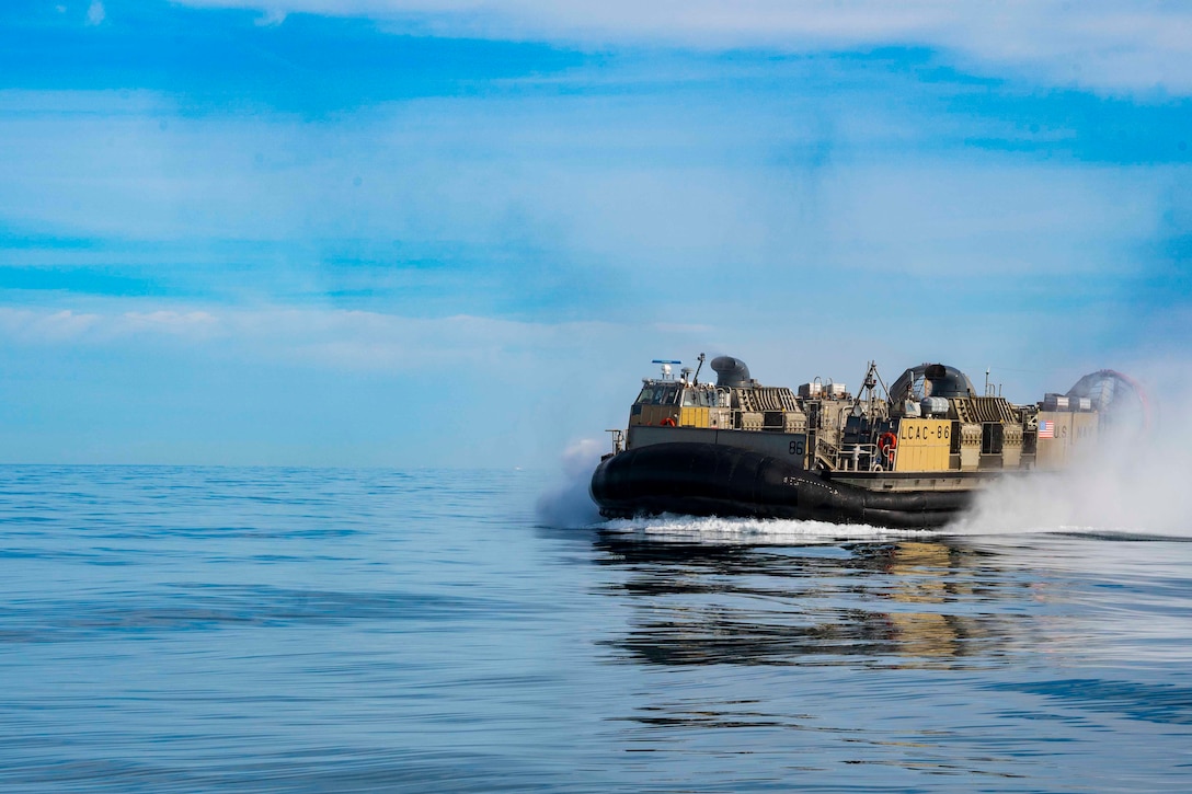 An air-cushioned landing craft moves through the water.