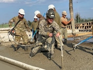 221215-N-N0748-1083 POTI, Georgia (Dec. 15, 2022) Builder 2nd Class Ian Potter, assigned to Naval Mobile Construction Battalion (NMCB) 11, works with a soldier assigned to the Georgian Land Force’s 2nd Brigade Engineering Company to vibrate and strengthen the concrete pad for the Railhead Project in Poti, Georgia, Dec. 15, 2022. NMCB 11 operates as a part of Navy Expeditionary Combat Command and is assigned to Commander, Task Force 68 for deployment across the U.S. Naval Forces Europe-Africa area of operations to defend U.S., allied, and partner interests. (U.S. Navy photo by Builder Constructionman Gabriella Coupe)
