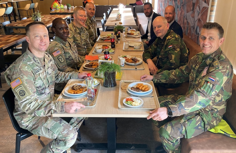 Army Col. Crystal Hills and Command Sgt. Maj. Terrell Brisentine from the 405th Army Field Support Brigade, along with Lt. Col. Blake Smith and Sgt. Maj. Alejandro Romar from Army Field Support Battalion-Benelux, sit down for lunch Feb. 9 with Royal Netherlands Army Material Logistics Command Brig. Gen. Mark Bours and Sgt. Maj. Leon Van Der Laar whose command supports Army Prepositioned Stocks-2 operations at the Eygelshoven APS-2 worksite with heavy equipment maintainers and mechanical and electronic repair technicians. (Photo by Sgt. 1st Class Guido Fermin)