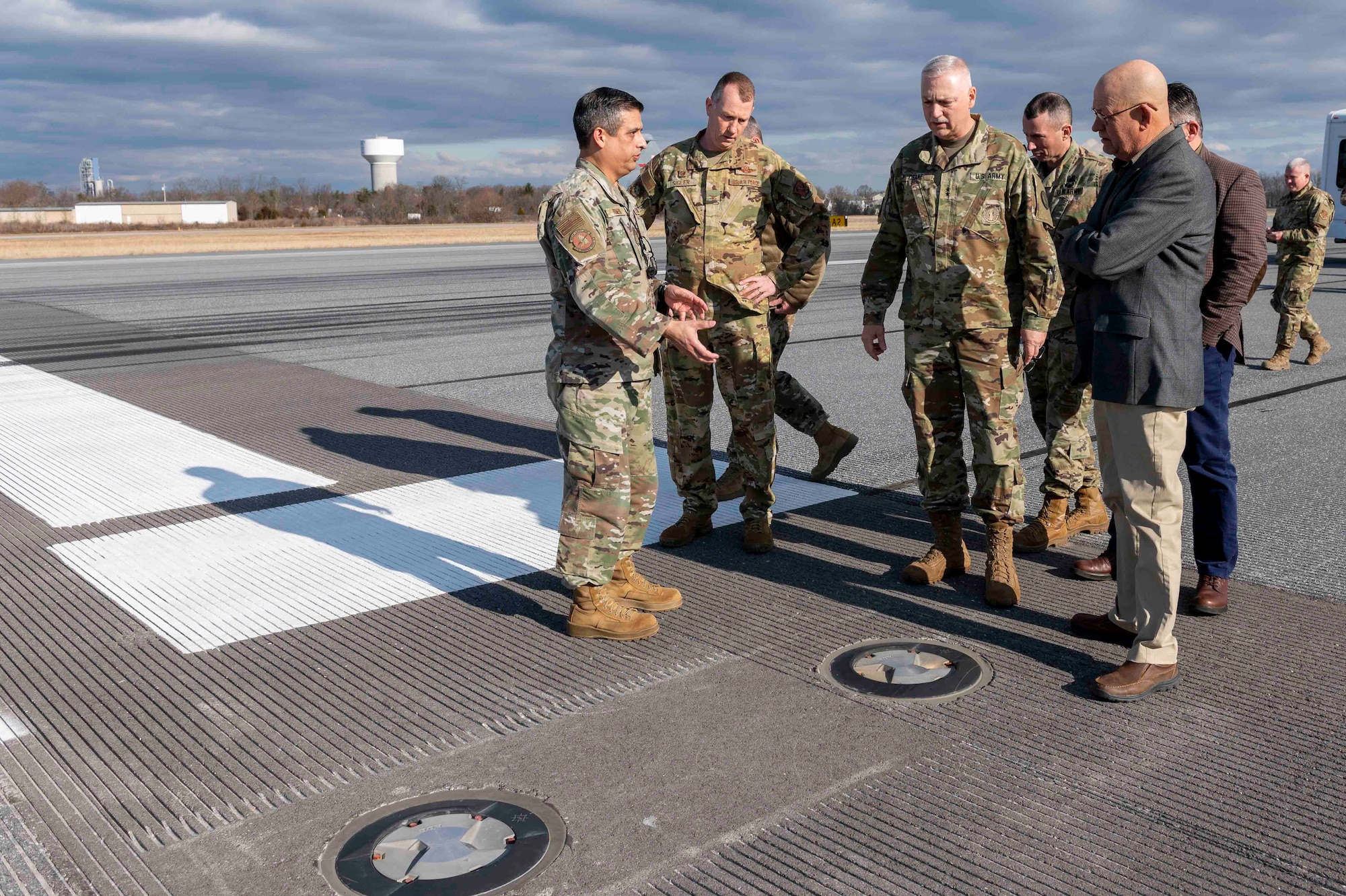 Senior Master Sgt. Alan Romero, left, 167th Operations Group airfield manager, points out embedded lighting on the runway at Shepherd Field, Eastern West Virginia Regional Airport, Martinsburg, West Virginia, Jan. 7, 2023, to Col. Christopher Sigler, 167th Operations Group commander, Maj. Gen. William Crane, The Adjutant General of the West Virginia National Guard and EWVRA officials, Nicolas Diehl and William Walkup.