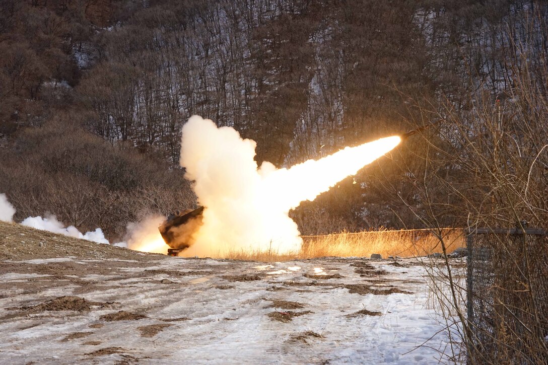 A rocket blasts from a rocket launcher in a snowy field.