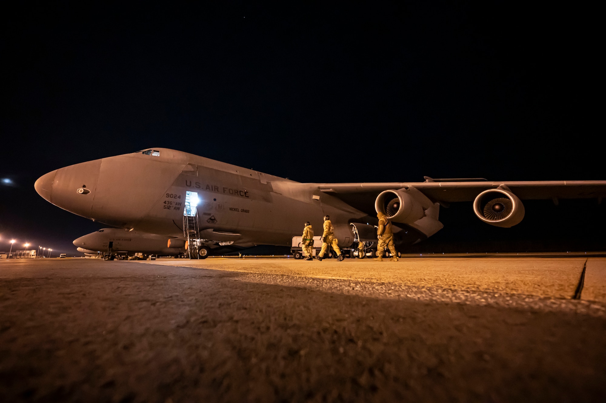 Airmen from the 436th Mission Generation Group walk to a C-5M Super Galaxy during a 436th MGG integration event on Dover Air Force Base, Delaware, Feb. 3, 2023. This event is part of the 436th MGG monthly readiness exercises that test the ability to perform job tasks in contested environments. (U.S. Air Force photo by Staff Sgt. Marco A. Gomez)