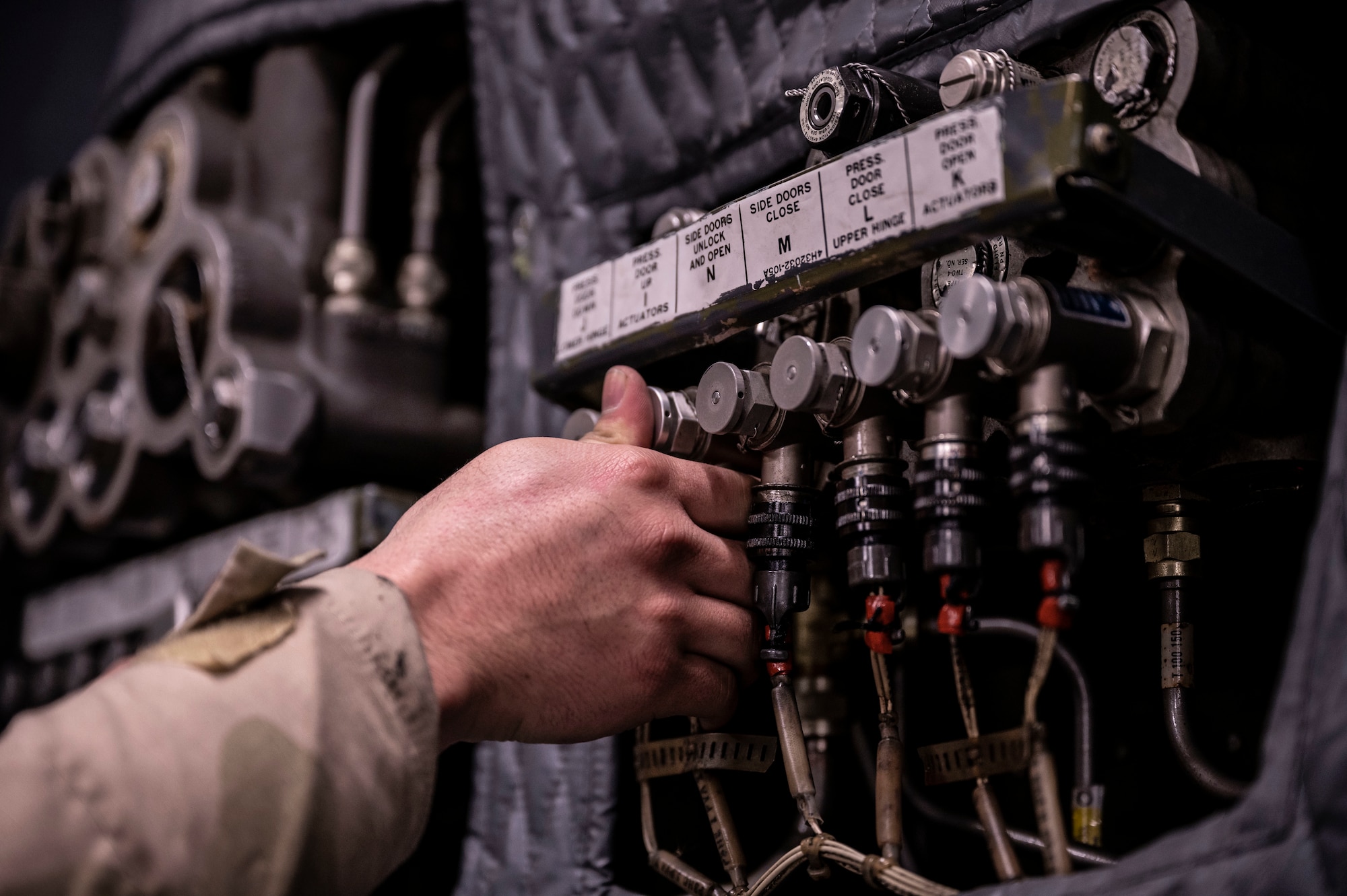 Airman 1st Class Gabriel Hinshaw, 436th Aircraft Maintenance Squadron crew chief, presses override valve on a C-5M Super Galaxy aft ramp complex during a 436th Mission Generation Group integration event on Dover Air Force Base, Delaware, Feb. 3, 2023. This event is part of the 436th MGG monthly readiness exercises that test the ability to perform job tasks in contested environments. (U.S. Air Force photo by Staff Sgt. Marco A. Gomez)