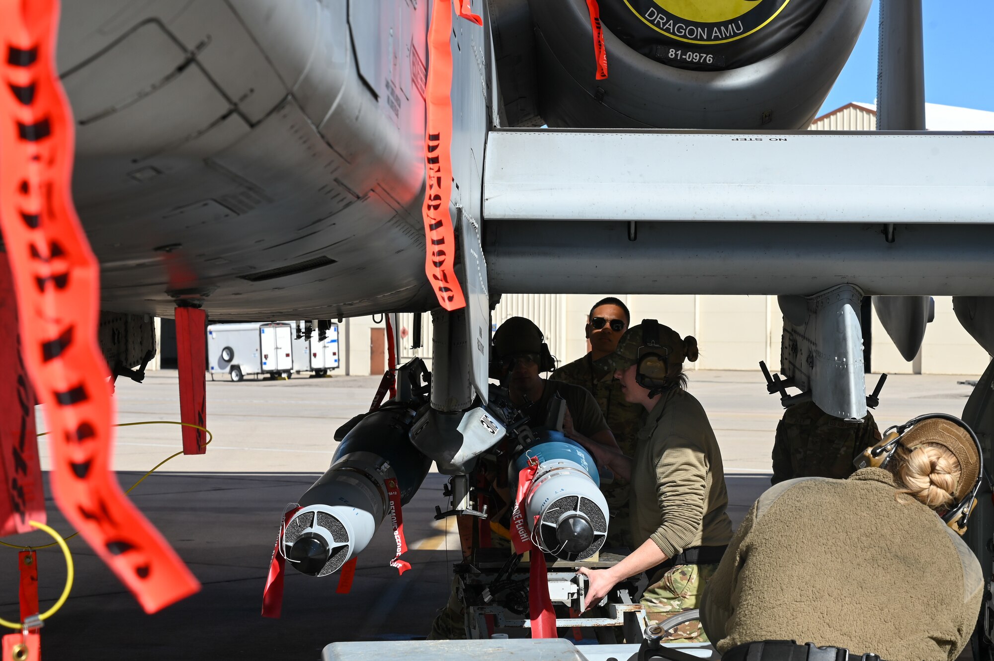 A photo of Airmen performing a simulated weapons load