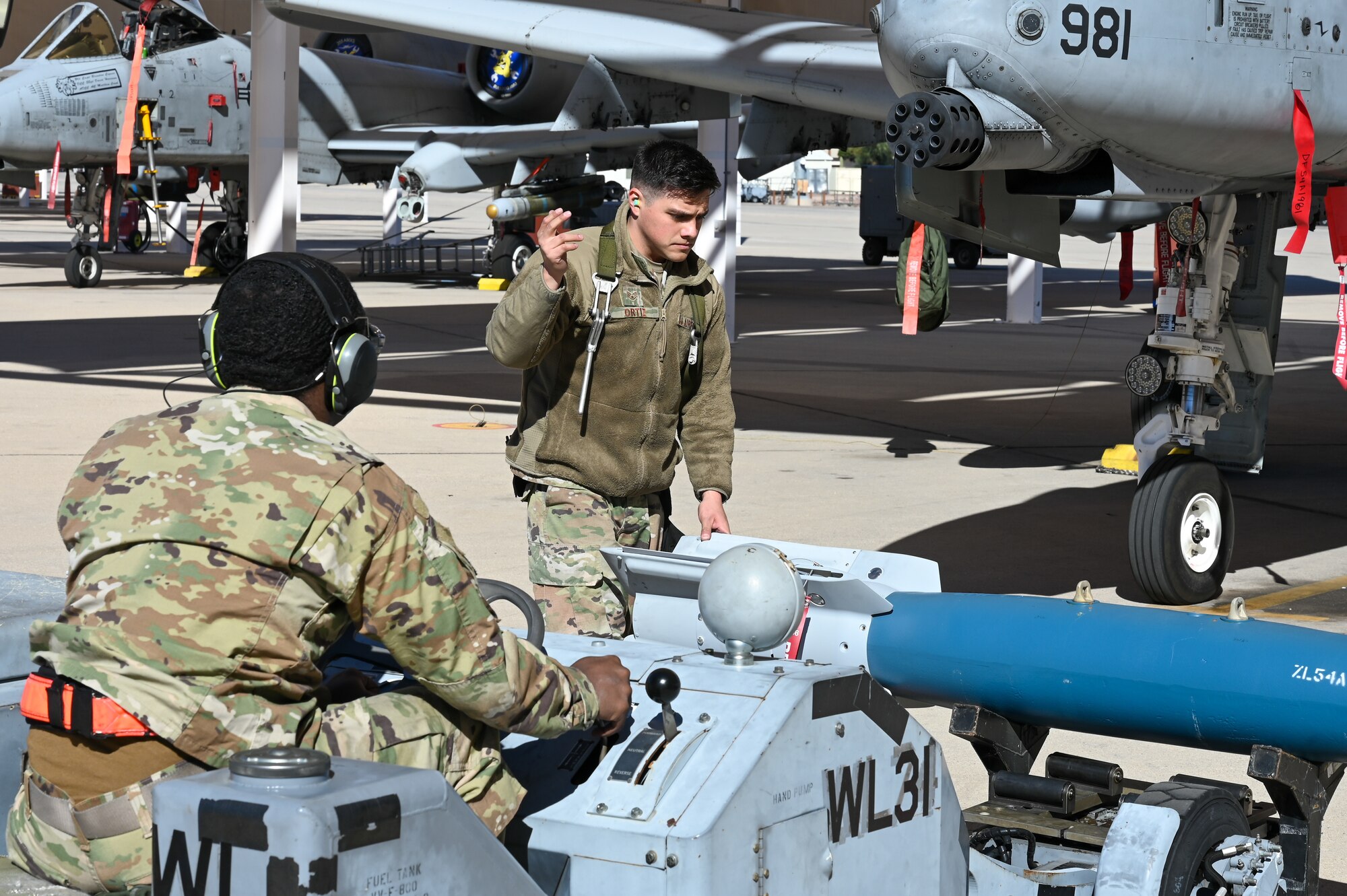 A photo of Airmen performing a simulated weapons load
