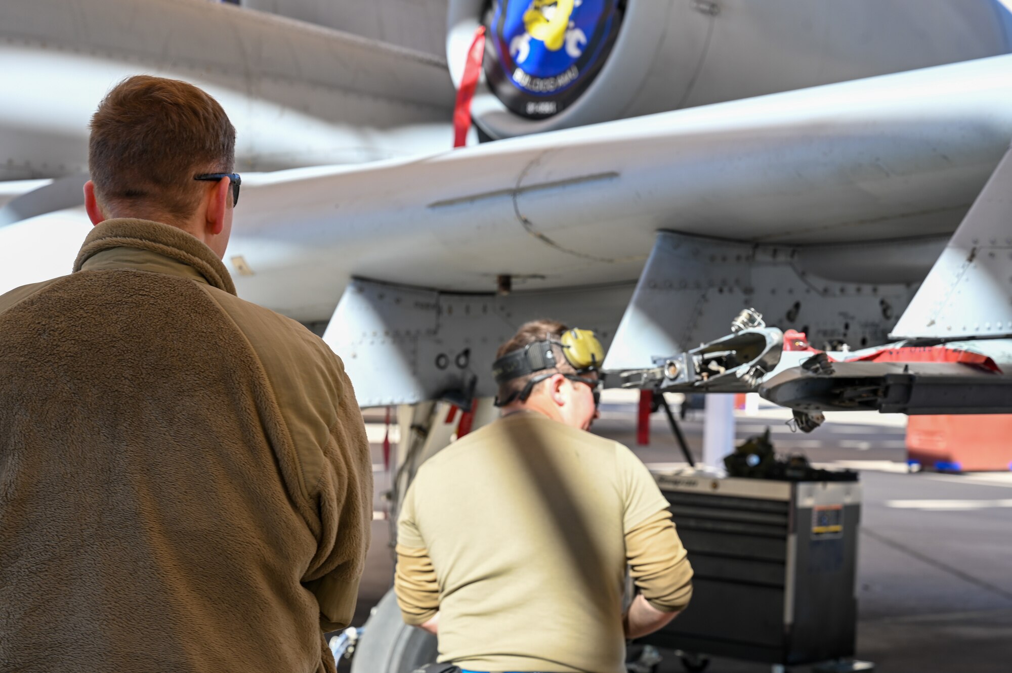 A photo of Airmen performing a simulated weapons load.