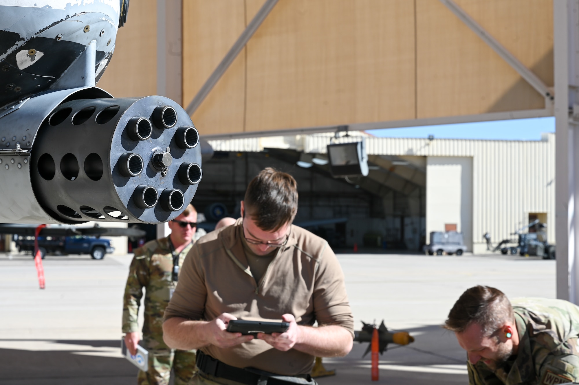 A photo of Airmen performing a simulated weapons load