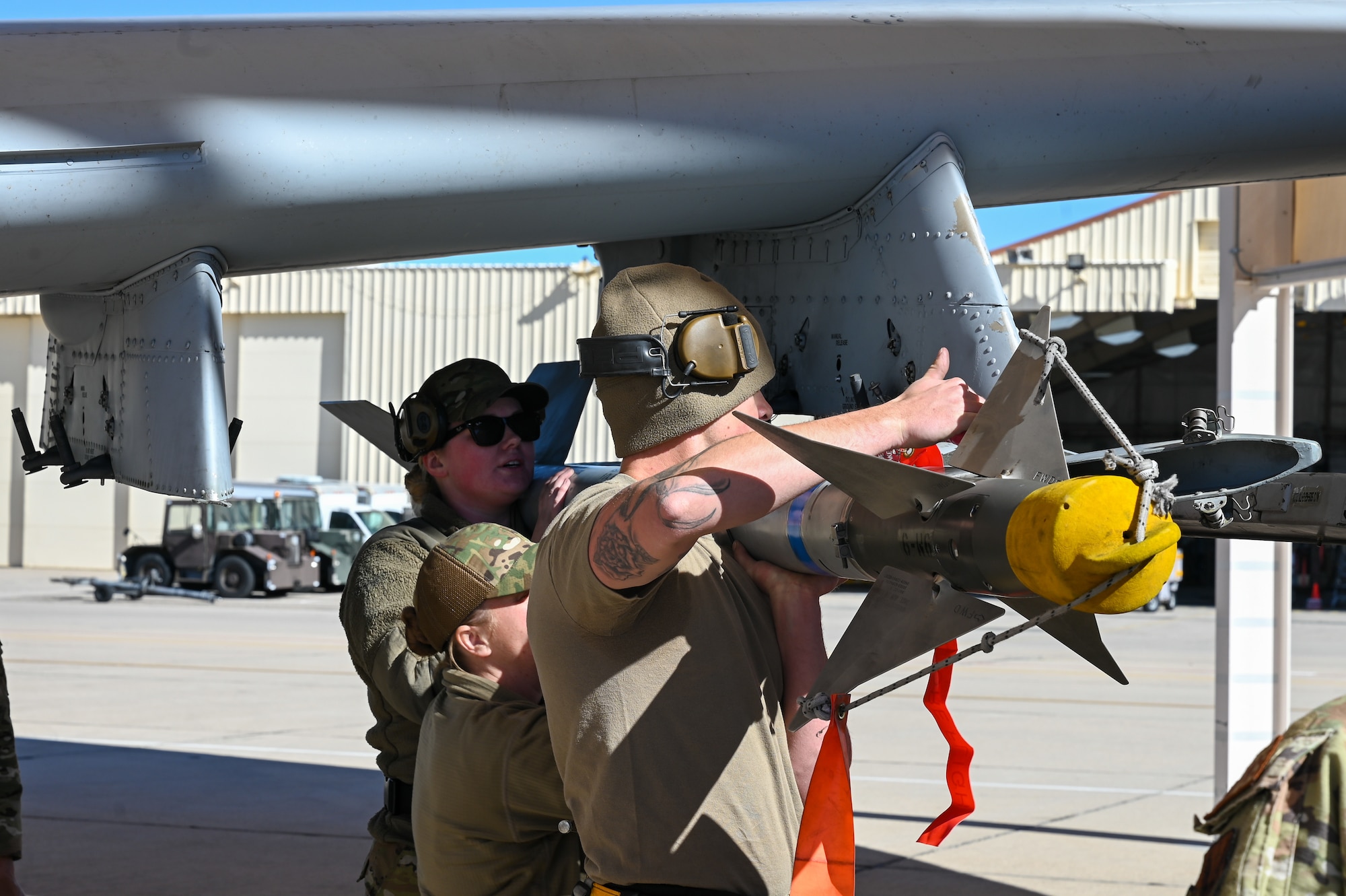 A photo of Airmen performing a simulated weapons load