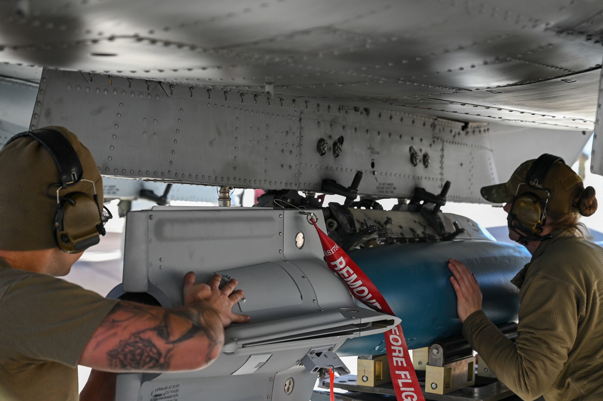 A photo of Airmen performing a simulated weapons load