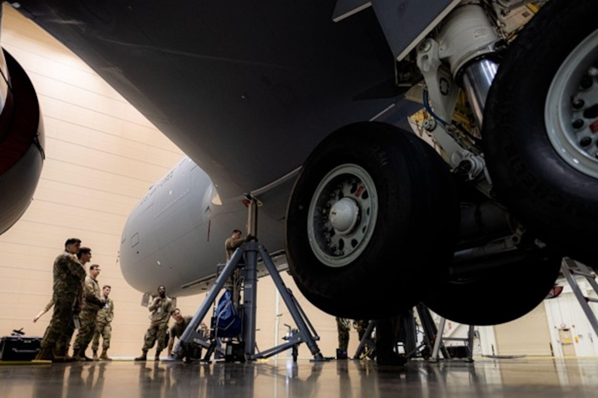 Group of Airmen operate maintenance equipment