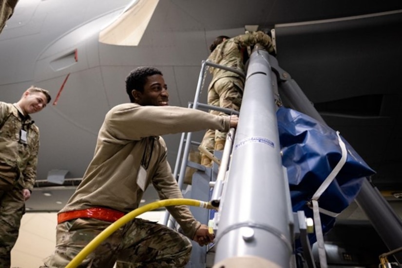 Man smiles as he operate a jack