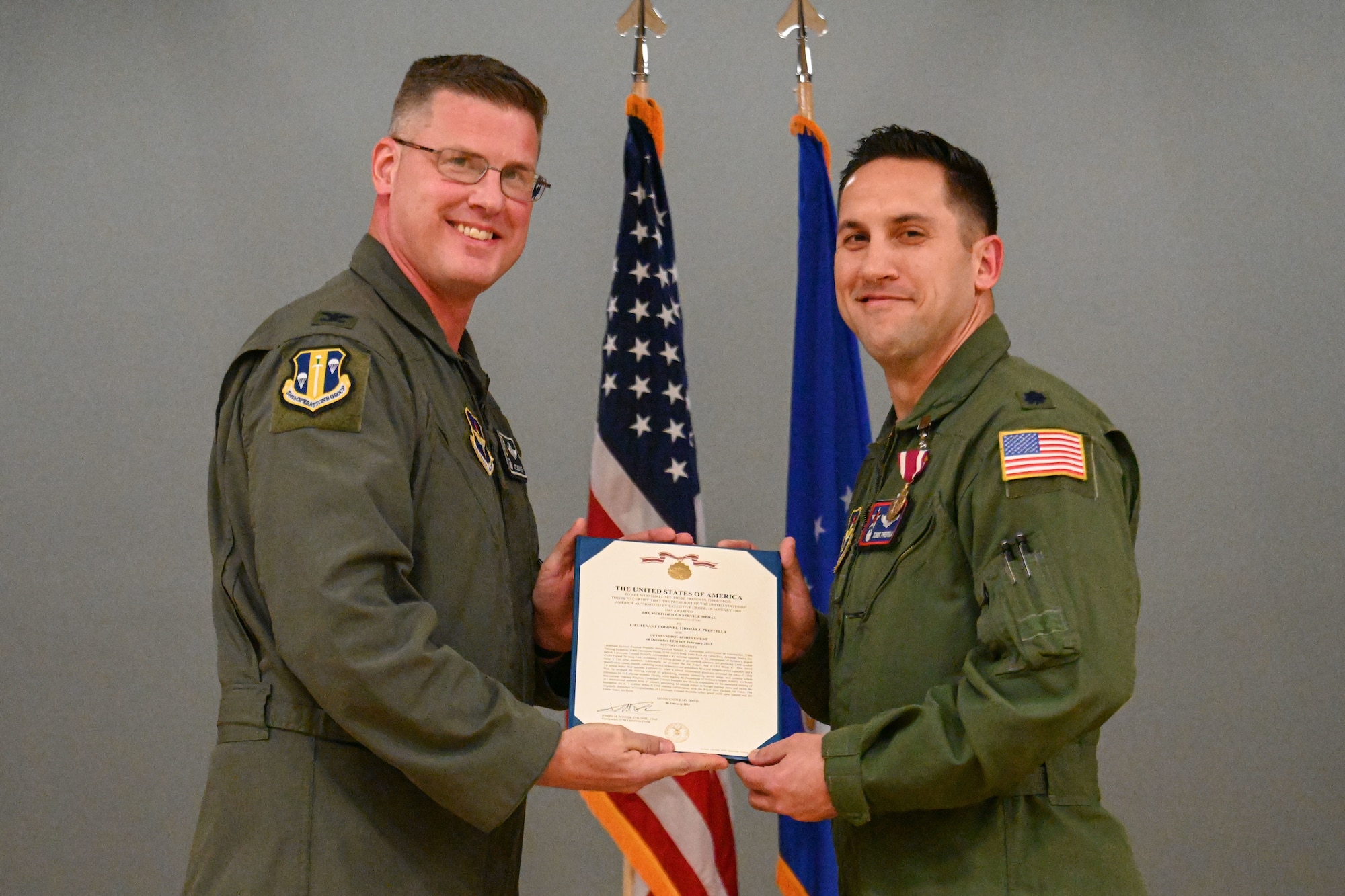 Men in uniform pose for a photo.