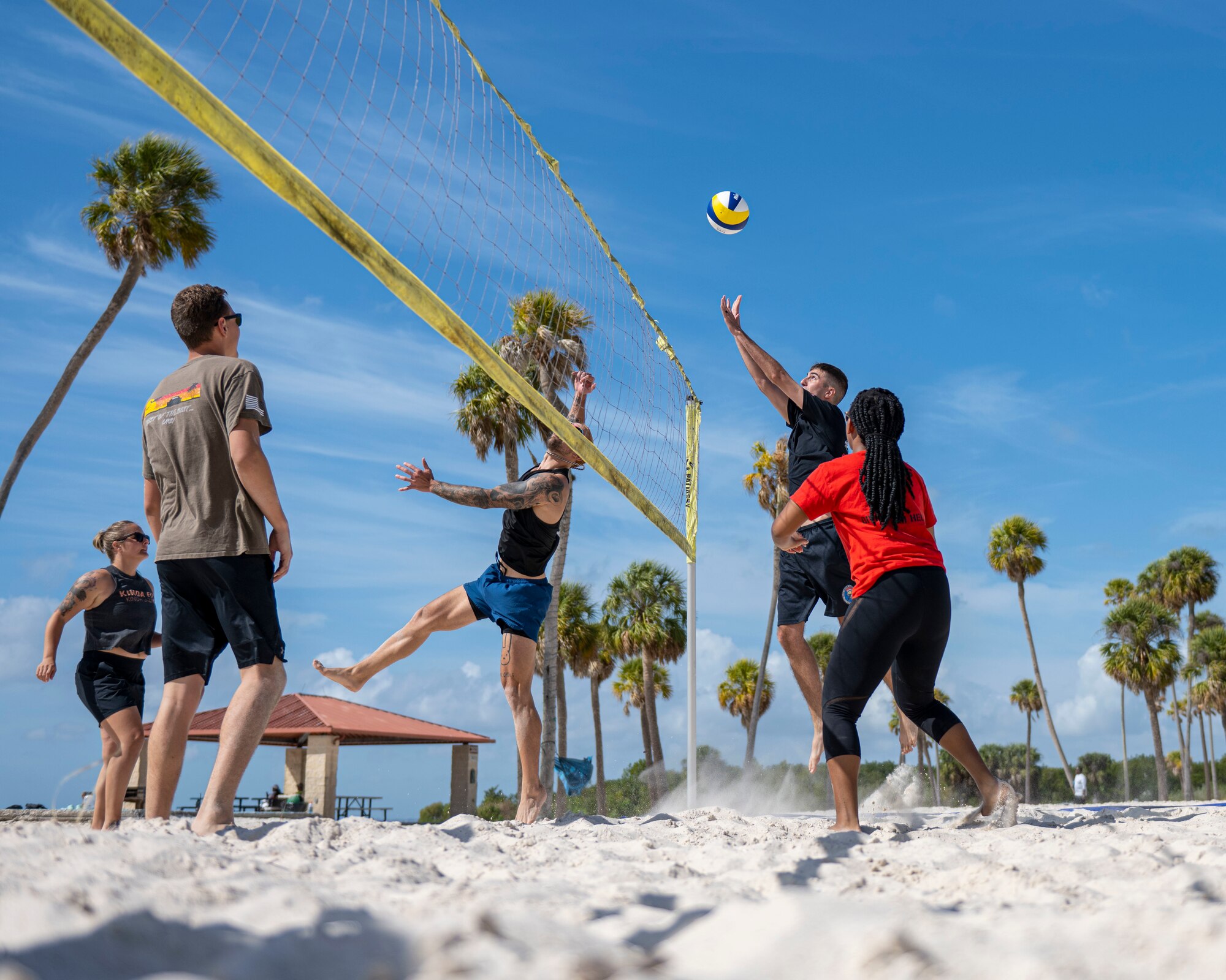 U.S. Airmen assigned to the 6th Air Refueling Wing participate in a volleyball game during wingman day at MacDill Air Force Base, Florida, Feb. 10, 2023. Throughout the Air Force, wingman days are held to help reduce negative behaviors, improve overall mental health, and increase social and spiritual connections along with personal resiliency. This wingman day included sports competitions and focused on the physical domain of resilience. The sports competitions included a formation run, golf, basketball, volleyball, cornhole, relay races, softball, kickball and more. (U.S. Air Force photo by Senior Airman Lauren Cobin)