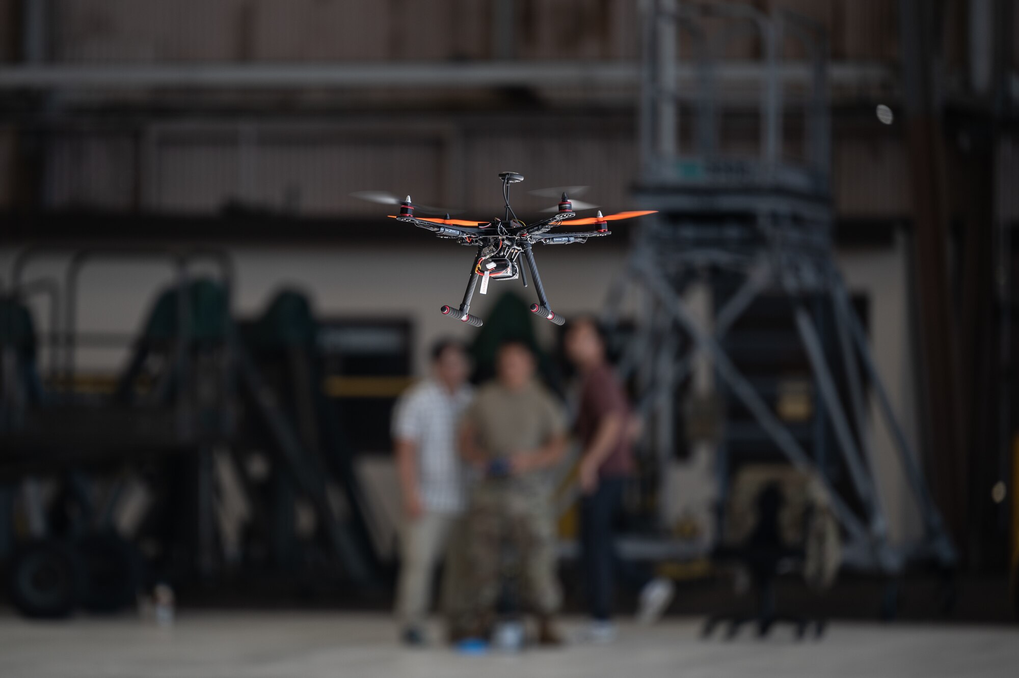 Maintenance airmen operate a trainer drone to enhance basic flight operation skills at Joint Base Pearl Harbor-Hickam, Hawaii, Feb. 8, 2023. Airmen assigned to the 15th Maintenance Squadron and the 154th Maintenance Squadron participated in a five-day course in preparation for an experimental maintenance inspection procedure to fly drones to observe the top of an aircraft. (U.S. Air Force photo by Staff Sgt. Alan Ricker)
