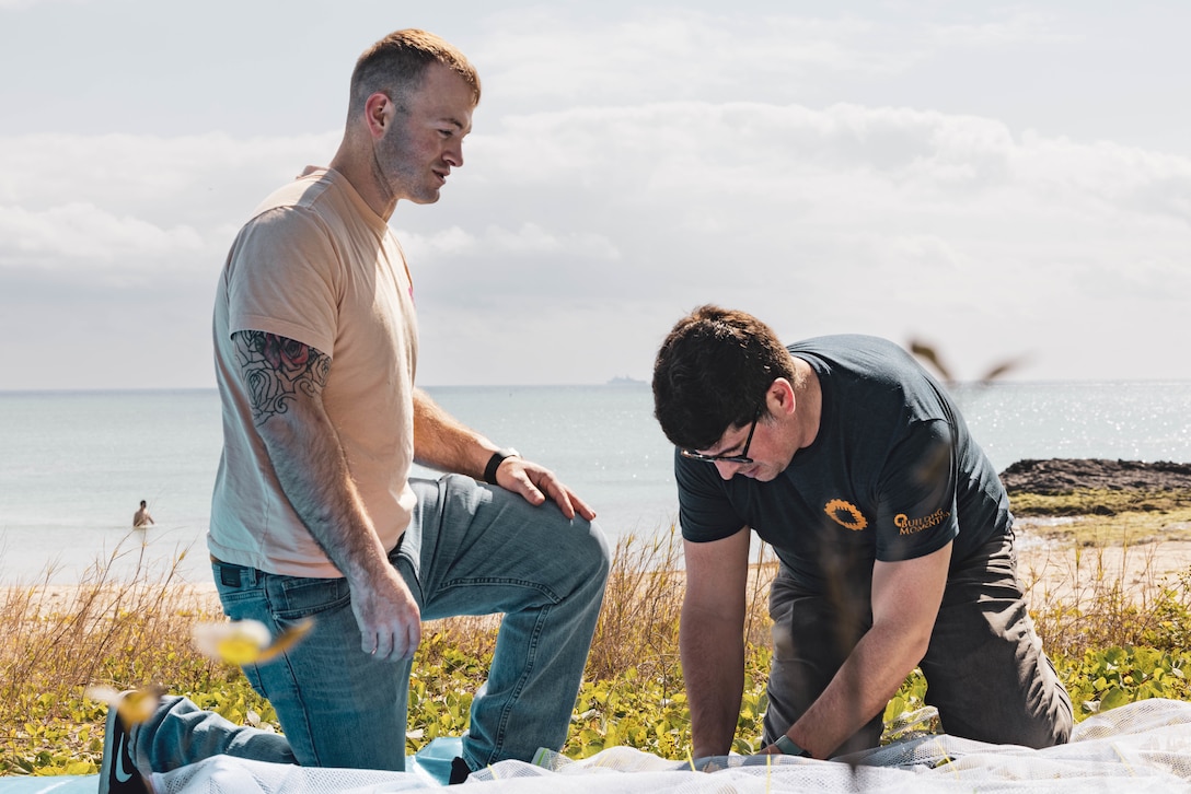 U.S. Marine Corps Sgt. Zachery Nirk, a water support technician with Marine Wing Support Squadron 172, 1st Marine Aircraft Wing, III Marine Expeditionary Force, and James Bellucci, a senior training associate with Building Momentum, participate in Innovation Boot Camp on Sea Glass Beach, Okinawa, Japan, Feb. 8, 2023. IBC was designed to teach Marines skills such as soldering, 3D printing, coding, and programming to create innovative products for the Marine Corps and to test Marines’ critical thinking skills. Nirk is a native of Blooming Prairie, Minnesota. (U.S. Marine Corps photo by Lance Cpl. Tyler Andrews)