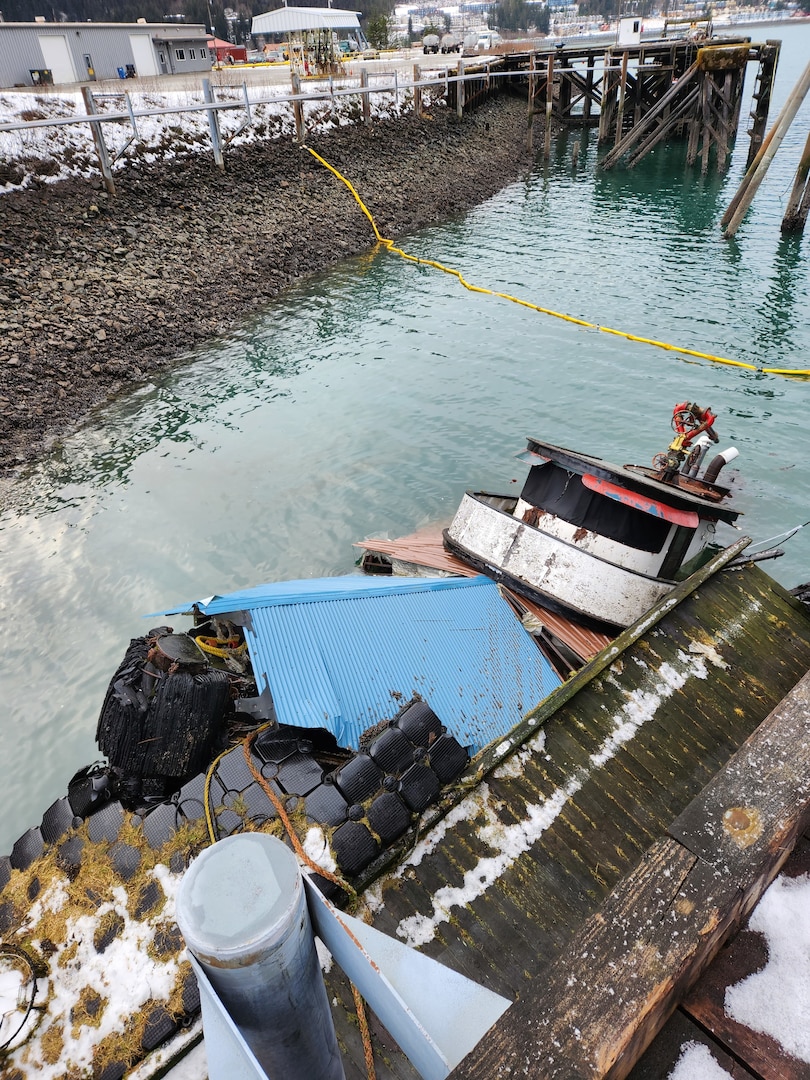 Tug vessel Tagish is partially submerged at the National Guard Dock in the vicinity of the Alaska Marine Lines yard in the Gastineau Channel, Juneau, Alaska, Dec. 29, 2022. Coast Guard Sector Juneau crew members and contractors are responding the incident. (U.S. Coast Guard photo courtesy of Sector Juneau)