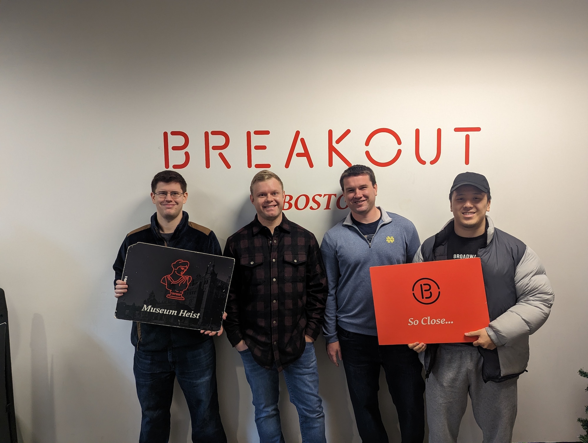 Four members of the Digital Directorate, Hanscom Air Force Base, Mass., pause for a photo after completing an escape room challenge as a morale-building event in Woburn, Mass., in December 2022. The escape room event was a time-bound immersive adventure experience paid for using Air Force UNITE funds which can be used by unit leaders for recreational activities to strengthen the bond between unit members. (U.S. Air Force courtesy photo)