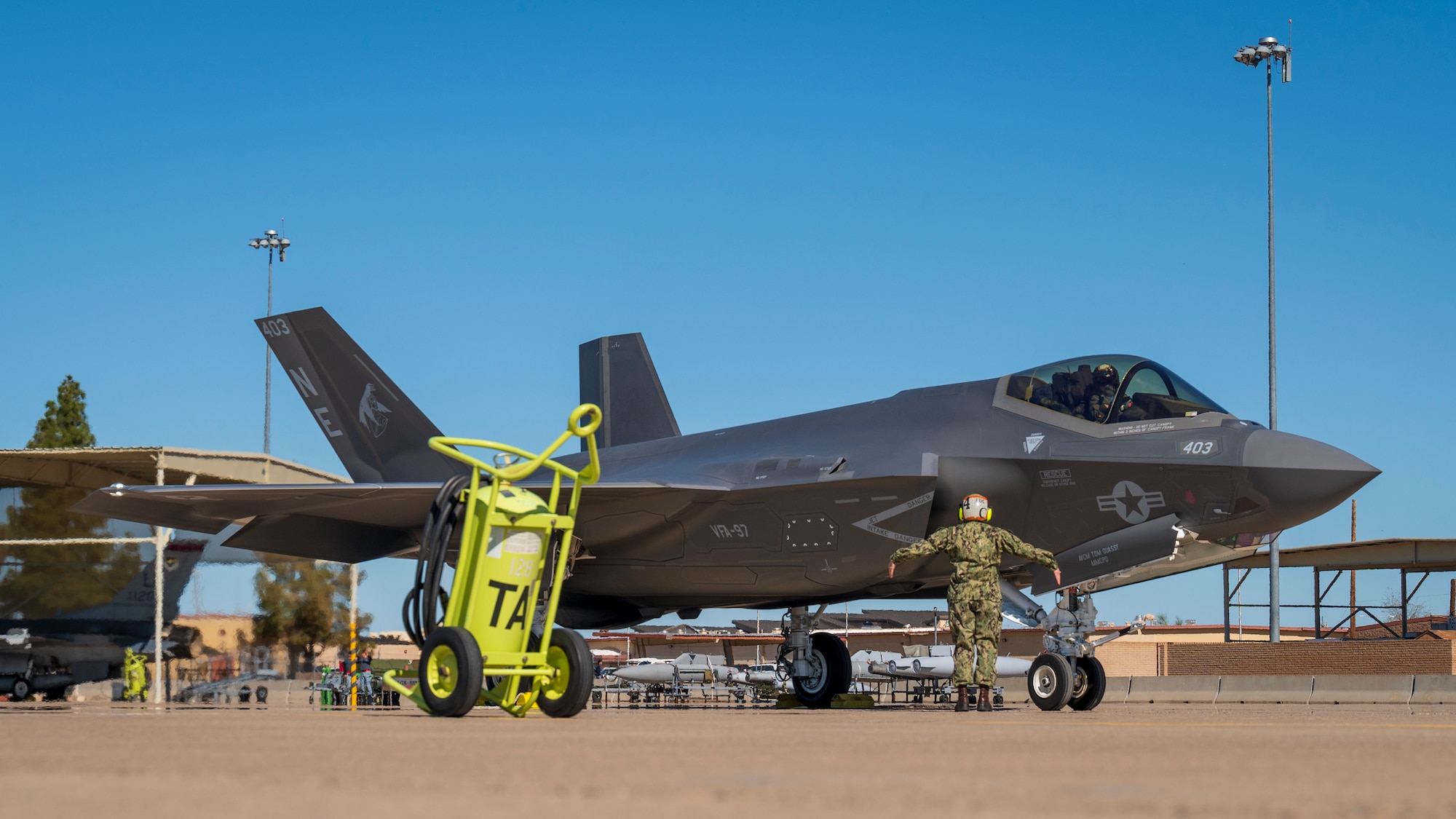 U.S. Navy ADC Tabitha Bledsoe communicates with the pilot of an F-35C Lightning II assigned to the “Warhawks” of Strike Fighter Squadron (VFA) 97, Lemoore, California, at Luke Air Force Base, Arizona, Feb. 7, 2023.