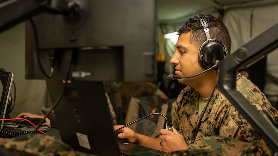 U.S. Marine Corps Sgt. Usbaldo Miranda, Jr., systems configuration coordinator, Marine Air Control Squadron 1, Marine Air Control Group 38, 3rd Marine Aircraft Wing (MAW), monitors his computer inside an expeditionary command and control (C2) node