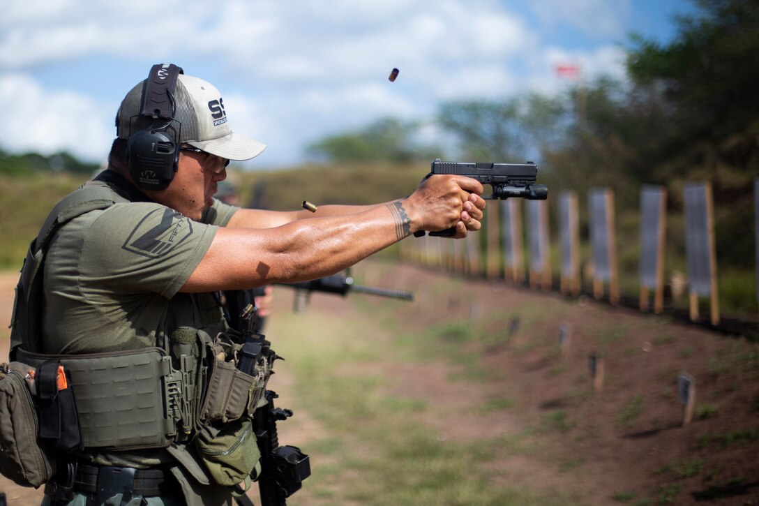 An officer with the Honolulu Police Department fires an M9 service pistol while conducting sustainment training at Pu’uloa Range Training Facility, Marine Corps Base Hawaii, Feb. 2, 2023. The training focused on utilizing patrol tactics in scenarios that simulated real-world situations. (U.S. Marine Corps photo by Lance Cpl. Terry Stennett III)