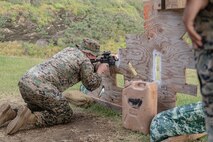 U.S. Marine Corps GySgt. Mitch Backer, S6 operations chief, 3rd Radio Battalion, Marine Corps Base Hawaii, performs a shooting drill during the Marine Corps Marksmanship Competition - Pacific at Crater Range, MCBH, Jan. 31, 2023. The MCMC-Pacific is one of four regional competitions throughout the Marine Corps in which U.S. service members and the Pacific's best shooters participate in a small arms marksmanship competition each year. (U.S. Marine Corps photo by Cpl. Holly Moore)
