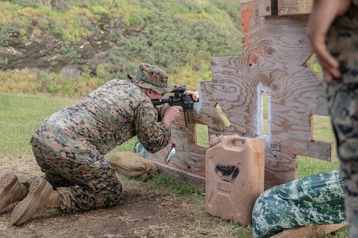 U.S. Marine Corps GySgt. Mitch Backer, S6 operations chief, 3rd Radio Battalion, Marine Corps Base Hawaii, performs a shooting drill during the Marine Corps Marksmanship Competition - Pacific at Crater Range, MCBH, Jan. 31, 2023. The MCMC-Pacific is one of four regional competitions throughout the Marine Corps in which U.S. service members and the Pacific's best shooters participate in a small arms marksmanship competition each year. (U.S. Marine Corps photo by Cpl. Holly Moore)